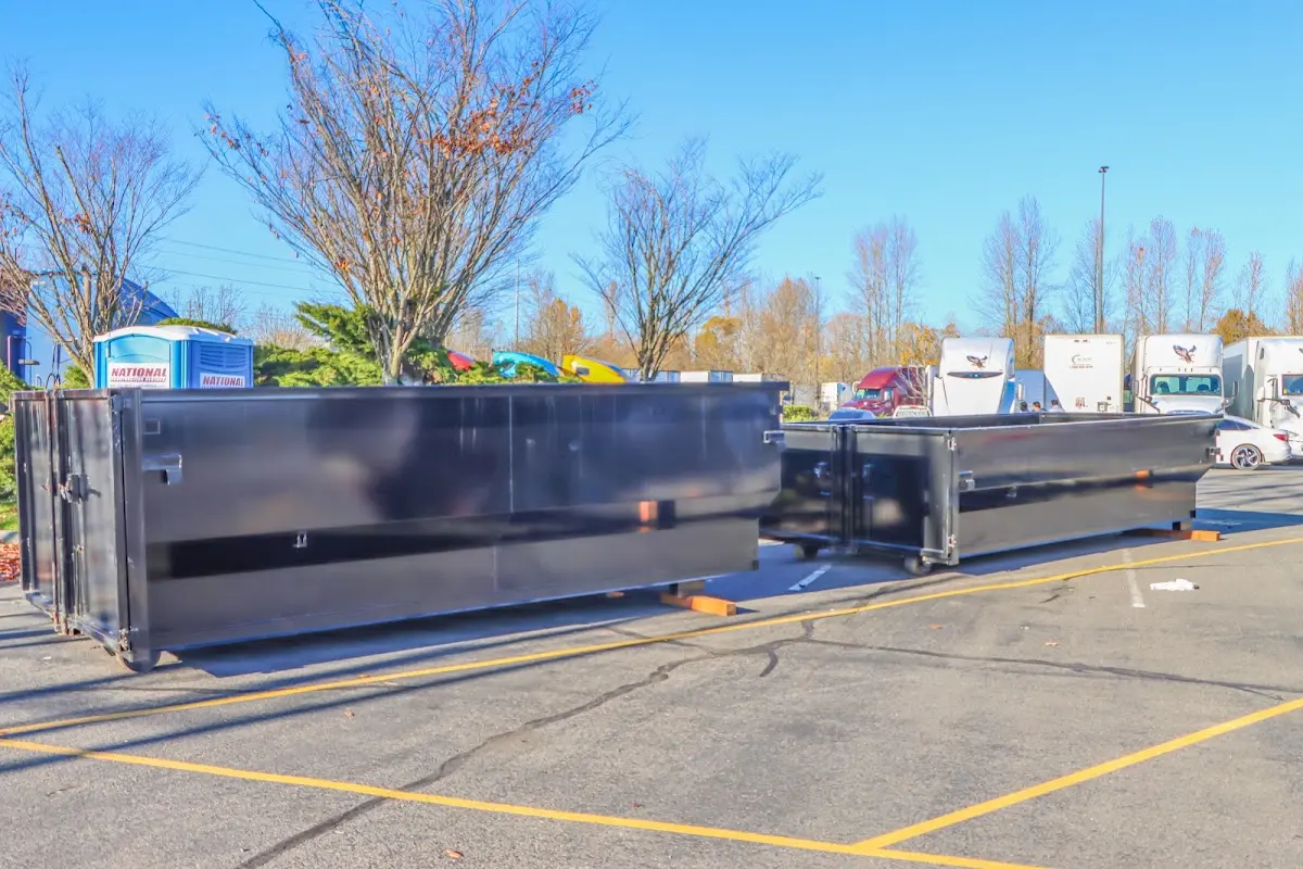 Professional dumpster rental service with roll-off container on residential driveway in City of Orange